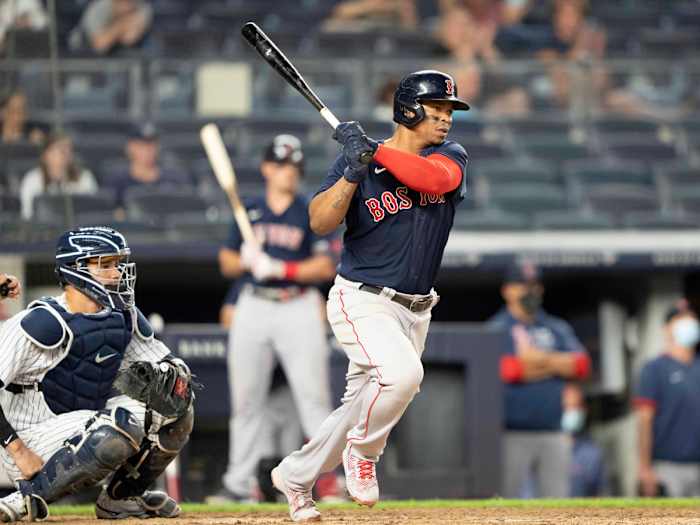 Jun 5, 2021; Bronx, New York, USA; Boston Red Sox third baseman Rafael Devers (11) hits an RBI single during the sixth inning against the New York Yankees at Yankee Stadium.